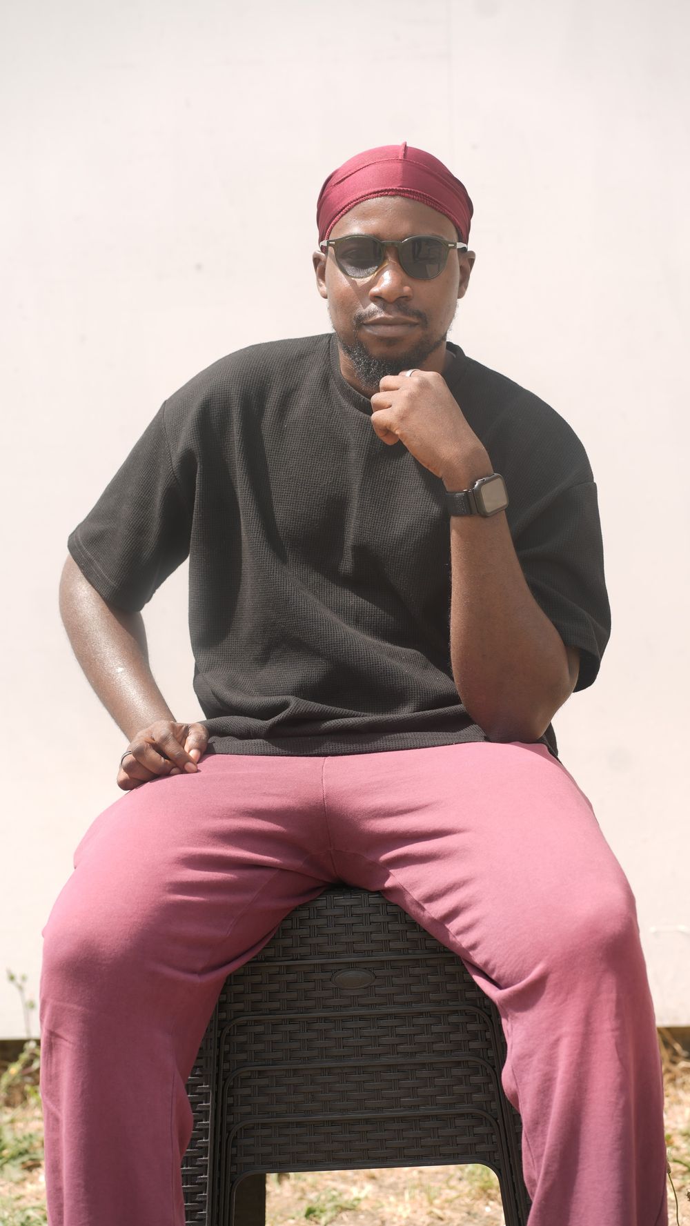 Portrait of Muheez Olaitan Ibrahim in a black tee and burgundy durag